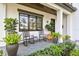 Charming front porch with rocking chairs, stylish planters, and decorative landscaping at 2402 W Parkland Blvd, Tampa, FL 33609