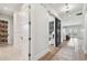 Hallway with hardwood floors, sliding barn door, and built-in storage at 2402 W Parkland Blvd, Tampa, FL 33609