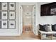 Bright hallway leading to a luxurious bathroom with marble flooring, a soaking tub and modern decor at 2402 W Parkland Blvd, Tampa, FL 33609