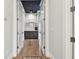 Bright hallway with hardwood floors, white walls, and a dark blue ceiling for a modern design at 2402 W Parkland Blvd, Tampa, FL 33609