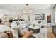 Bright and airy living room with a large sectional sofa, decorative rug, and stylish light fixture at 2402 W Parkland Blvd, Tampa, FL 33609