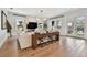 Bright living room features hardwood floors, modern lighting, and an elegant console table with seating at 2402 W Parkland Blvd, Tampa, FL 33609