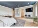 Bright main bedroom featuring hardwood floors, neutral decor, large windows, seating and wall-mounted tv at 2402 W Parkland Blvd, Tampa, FL 33609