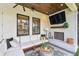 Comfortable outdoor living space with a fireplace, plush seating, and a mounted television at 2402 W Parkland Blvd, Tampa, FL 33609