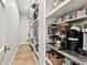 Spacious walk-in pantry featuring custom shelving and countertop at 2402 W Parkland Blvd, Tampa, FL 33609