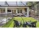 A beautiful backyard patio boasts a fireplace, comfortable lounge furniture, and lush green turf at 2402 W Parkland Blvd, Tampa, FL 33609