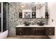Stylish bathroom features double vessel sinks and a mosaic tile wall with modern accents at 2460 Beacon Groves Blvd, Palm Harbor, FL 34683