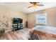 Bright and airy bedroom with a tv, artwork and wood flooring at 2460 Beacon Groves Blvd, Palm Harbor, FL 34683