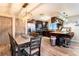 Modern kitchen and dining area with dark cabinetry, stainless steel appliances, and a stylish breakfast bar at 2460 Beacon Groves Blvd, Palm Harbor, FL 34683