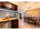 Open concept kitchen and dining area featuring wooden floors, stainless appliances and stylish decor at 2460 Beacon Groves Blvd, Palm Harbor, FL 34683