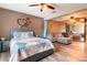 Spacious main bedroom with a bed, seating area, accent wall, and mirrored closet doors at 2460 Beacon Groves Blvd, Palm Harbor, FL 34683