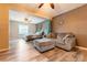 Spacious main bedroom with a bed, seating area, accent wall, and wood flooring at 2460 Beacon Groves Blvd, Palm Harbor, FL 34683