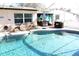 Enjoy the outdoors in this pool with lounge seating and a covered patio at 2460 Beacon Groves Blvd, Palm Harbor, FL 34683