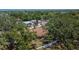 A tranquil aerial view shows the property nestled among the mature trees with the fence line in the background at 2505 E 19Th Ave, Tampa, FL 33605