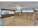 Spacious finished basement area with unique stone wall accents, recessed lighting, and tile flooring at 2505 E 19Th Ave, Tampa, FL 33605