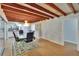 Bright dining area featuring wood beam ceiling, elegant chandelier and sliding glass doors to the kitchen at 2505 E 19Th Ave, Tampa, FL 33605