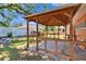 View of backyard gazebo with seating area, shade, and a manicured yard with white fence at 2505 E 19Th Ave, Tampa, FL 33605