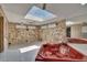 Indoor hot tub room featuring stone walls, a skylight, and mirror creating a relaxing spa-like experience at 2505 E 19Th Ave, Tampa, FL 33605