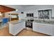 Bright kitchen featuring white cabinets, granite counters, stainless steel appliances, and wood look flooring at 2505 E 19Th Ave, Tampa, FL 33605