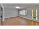 Neutral-toned living room with light walls, wood-look floors and natural light from the window and glass door at 2505 E 19Th Ave, Tampa, FL 33605
