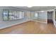 Bright living room with wood floors, a mirrored wall, a large window with blinds and a closet in view at 2505 E 19Th Ave, Tampa, FL 33605
