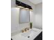 This modern bathroom features a large mirror with decorative lighting and stylish fixtures at 280 41St Ave, St Pete Beach, FL 33706