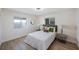 Bright bedroom featuring wood floors, contemporary furniture, and plenty of natural light from two windows at 280 41St Ave, St Pete Beach, FL 33706
