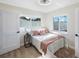 Bright bedroom with two windows, light wood floors, and pink accents at 280 41St Ave, St Pete Beach, FL 33706