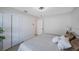 This bedroom features wood floors, a ceiling fan, and a closet for extra storage at 280 41St Ave, St Pete Beach, FL 33706