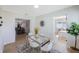 Bright dining room with a glass table, white chairs, and views of other rooms at 280 41St Ave, St Pete Beach, FL 33706