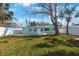 Charming single-story home featuring a well-manicured lawn, mature trees and a welcoming front entrance at 280 41St Ave, St Pete Beach, FL 33706
