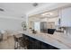 Remodeled kitchen featuring an island with bar seating, stainless steel appliances, and white shaker cabinets at 280 41St Ave, St Pete Beach, FL 33706