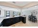 Bright open layout with a kitchen featuring an island with bar seating and view into the living room at 280 41St Ave, St Pete Beach, FL 33706