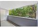 Outdoor balcony with railings and views of lush trees and parked cars at 301 2Nd N St # 13, St Petersburg, FL 33701