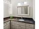Bathroom vanity with dark countertops, modern lighting, and white cabinets at 301 2Nd N St # 13, St Petersburg, FL 33701