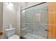 Bathroom with a tiled shower with a glass door, neutral walls, and tile floors at 301 2Nd N St # 13, St Petersburg, FL 33701