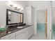 Bathroom featuring a dark vanity, and a tiled shower in the background at 301 2Nd N St # 13, St Petersburg, FL 33701