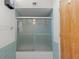 Bathroom featuring glass shower door and tiled walls at 301 2Nd N St # 13, St Petersburg, FL 33701