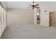 Bedroom featuring neutral walls, carpeted floors, ceiling fan, and a bathroom vanity area at 301 2Nd N St # 13, St Petersburg, FL 33701
