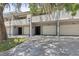 Condominium exterior featuring individual garages and an inviting facade with mature landscaping at 301 2Nd N St # 13, St Petersburg, FL 33701