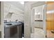 A spacious laundry room with a modern washer and dryer and wire shelving for storage at 301 2Nd N St # 13, St Petersburg, FL 33701
