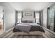 This main bedroom includes a king-size bed, dual windows, and wood-look flooring for a comfortable space at 3056 Pointeview Dr, Tampa, FL 33611