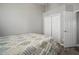 Bedroom with a queen-sized bed, closet, and grey walls at 3056 Pointeview Dr, Tampa, FL 33611