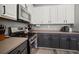 Modern kitchen featuring stainless steel appliances, updated countertops, and updated white and grey cabinets at 3056 Pointeview Dr, Tampa, FL 33611