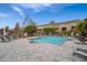 Community pool featuring lounge chairs, lush tropical landscaping, and a brick-paved deck area at 3056 Pointeview Dr, Tampa, FL 33611