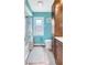 Bathroom featuring light blue walls, and wood cabinets and floors, with a tub and a window at 3122 Lake Valencia E Ln, Palm Harbor, FL 34684