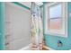 This bathroom offers a shower-tub combo with a custom shower curtain at 3122 Lake Valencia E Ln, Palm Harbor, FL 34684