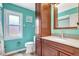 Bathroom featuring wood cabinets and floors with plenty of natural light coming from the window at 3122 Lake Valencia E Ln, Palm Harbor, FL 34684