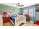 Bedroom featuring bed with stuffed animals, posters, light wood floor, and light green walls at 3122 Lake Valencia E Ln, Palm Harbor, FL 34684