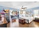 Light-filled bedroom with wood floors, stylish furnishings, and sliding glass doors to the patio at 3122 Lake Valencia E Ln, Palm Harbor, FL 34684